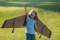 Child boy dreams and travels. Boy with airplane toy outdoors. Happy child playing with toy airplane outdoors in summer Royalty Free Stock Photo