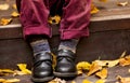 Child boy dressed in crimson trousers and black shoes with colo Royalty Free Stock Photo