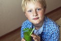 Child boy drinking green smoothie Royalty Free Stock Photo