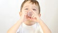 Child boy drinks liquid syrup, medicine. Close-up. Treatment of a child.
