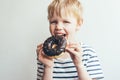 A child boy eats a chocolate donut Royalty Free Stock Photo