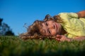 Child boy enjoying on grass field and dreaming. Royalty Free Stock Photo