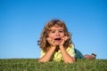 Child boy enjoying on grass field and dreaming. Royalty Free Stock Photo