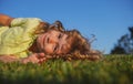 Child boy enjoying on grass field and dreaming. Royalty Free Stock Photo