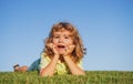 Child boy enjoying on grass field and dreaming. Royalty Free Stock Photo