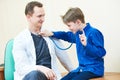 Child boy examining male doctor with stethoscope in hospital Royalty Free Stock Photo