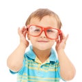 Child, boy and frames or glasses in studio, eyes and vision support by white background. Male person, kid and