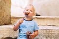 Child boy with Fritule - Croatian sweet pastry, cookies, homemade fritters Royalty Free Stock Photo