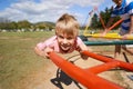 Child, boy and fun on playground in portrait, smile and outdoor adventure on merry go round at park. Happy male person Royalty Free Stock Photo