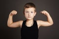 Child.Funny Little Boy showing his muscles