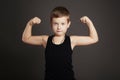 Child.Funny Little Boy showing his muscles
