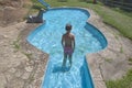 Child boy at guitar-shaped swimming pool, Losar de la Vera, Spain Royalty Free Stock Photo