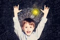 Child boy with hands up and lightbulb. Concept Ideas and projects