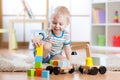 Child boy is happy to play toy building blocks and loader car Royalty Free Stock Photo