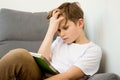 Child boy hardly working on his homework, studying online at home with books and laptop Royalty Free Stock Photo