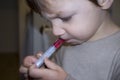Child boy having antipyretic medicine with measuring syringe Royalty Free Stock Photo