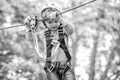 Child boy having fun at adventure park. Happy child climbing in the trees. Happy Little child climbing a tree. Balance Royalty Free Stock Photo