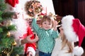 Child boy helps mother and father to decorate Royalty Free Stock Photo