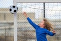 Child boy hold classic soccer ball on playground. Kid holding football ball in studio. Kid playing with ball. Sport Royalty Free Stock Photo