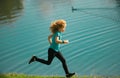 Child boy jogging in park outdoor. Sporty kid running in nature. Active healthy child boy runner jogging outdoor. Active