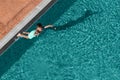 Child boy jumping into blue water of swimming pool. Kids fun leisure activity, sport at summer resort. View from above Royalty Free Stock Photo