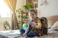 A child boy with backpack is playing with a toy airplane and a globe of the earth. Going on a journey towards adventure Royalty Free Stock Photo