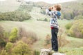 Child boy looking through binocular to the country side