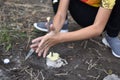 Child boy makes fire by friction method. Survival skills in the forest.