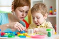 Child boy and mother playing colorful clay toy Royalty Free Stock Photo