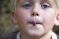 Child boy picking wild blueberries in a blueberry forest Royalty Free Stock Photo