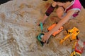 Child boy play construction vehicle toy in sand playground Royalty Free Stock Photo