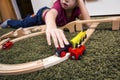 Child boy play with wooden train, build toy railroad at home or Royalty Free Stock Photo