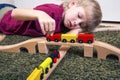 Child boy play with wooden train, build toy railroad at home or Royalty Free Stock Photo