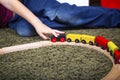 Child boy play with wooden train, build toy railroad at home or Royalty Free Stock Photo