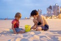 Child, boy, playing on the beach in Tel Aviv in the evening