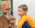 Child boy playing with cute robot. Concept of modern lifestyle and emerging technologies