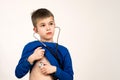 Child boy playing doctor with stethoscope in hands. Pediatric, healthcare and people concept