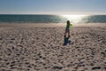 Child boy is playing with a frisbee on the beach. Boy Catching a Frisbee. Royalty Free Stock Photo