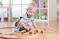 Child boy playing in his room with a toy train Royalty Free Stock Photo