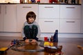 Child boy playing in living room with a toy train Royalty Free Stock Photo