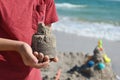 A little boy builds a sand castle. Playing with sand and toys for the ocean. A holiday with the kids at the resort.