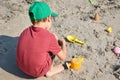 A little boy builds a sand castle. Playing with sand and toys for the ocean. A holiday with the kids at the resort. Royalty Free Stock Photo