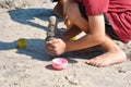 A little boy builds a sand castle. Playing with sand and toys for the ocean. A holiday with the kids at the resort.