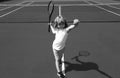 Child boy playing tennis on outdoor court. Little girl with tennis racket and ball in sport club. Active exercise for Royalty Free Stock Photo