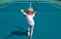 Child boy playing tennis on outdoor court. Little girl with tennis racket and ball in sport club. Active exercise for Royalty Free Stock Photo