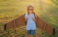 Child boy playing with toy airplane wings. Dream of becoming a pilot. Superhero flying. Boy dreams of flying. Carefree