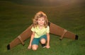 Child boy playing with toy airplane wings. Dream of becoming a pilot. Superhero flying. Funny kid dreaming about summer Royalty Free Stock Photo