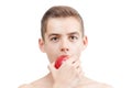 Child boy portrait eating ripe red apple isolated. Royalty Free Stock Photo