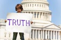 Protester boy child holding sign demanding truth