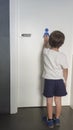 Child boy pushing public toilet door by himself